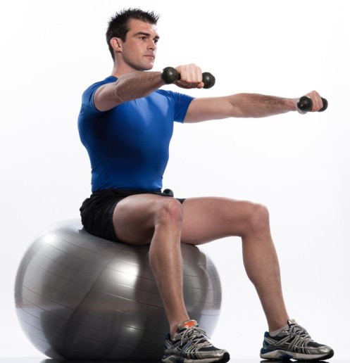 Dumbbell exercises on a gym ball can increase core muscle stimulation as you try to keep your body stable